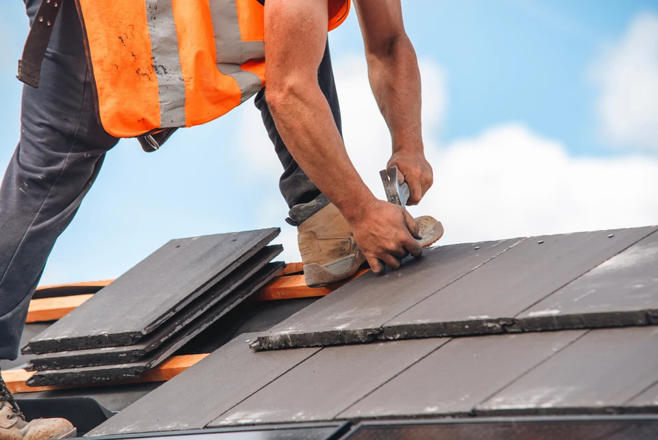 Extérieur, vue en contre-plongée d'une toiture en construction sous ciel bleu azur